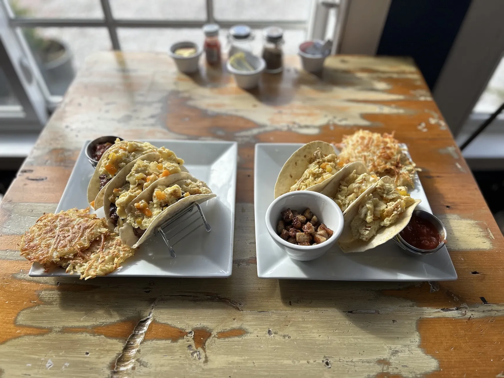2 different plates full of tacos